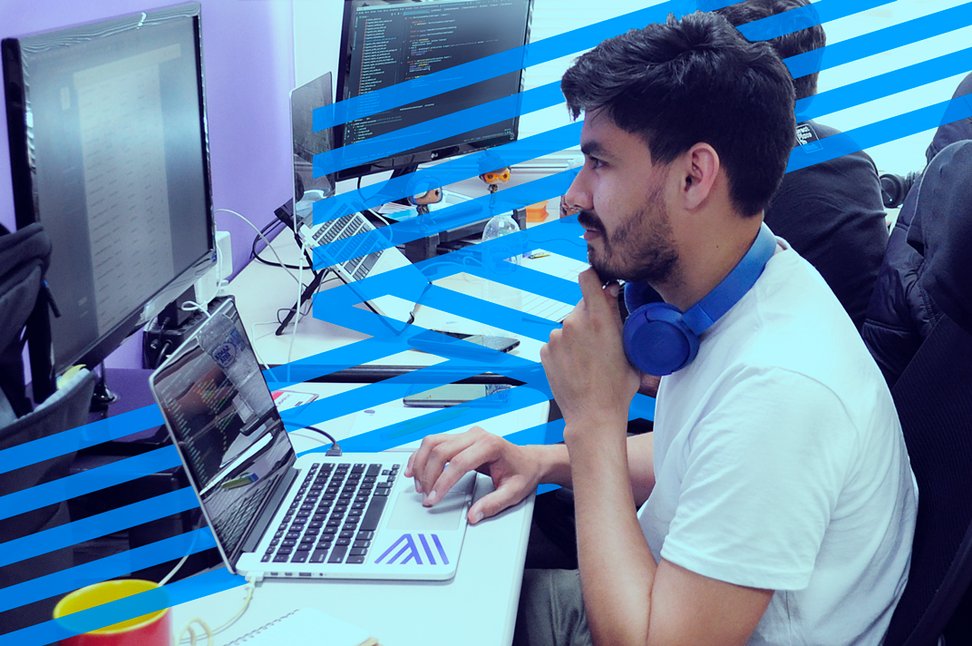 Young man thinking in front of his computers