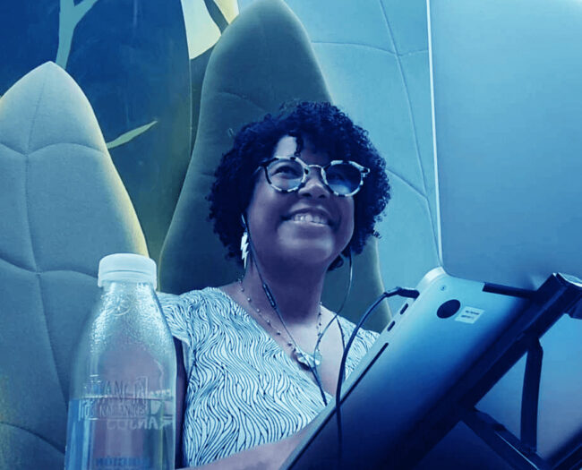 woman smiling in front of a notebook