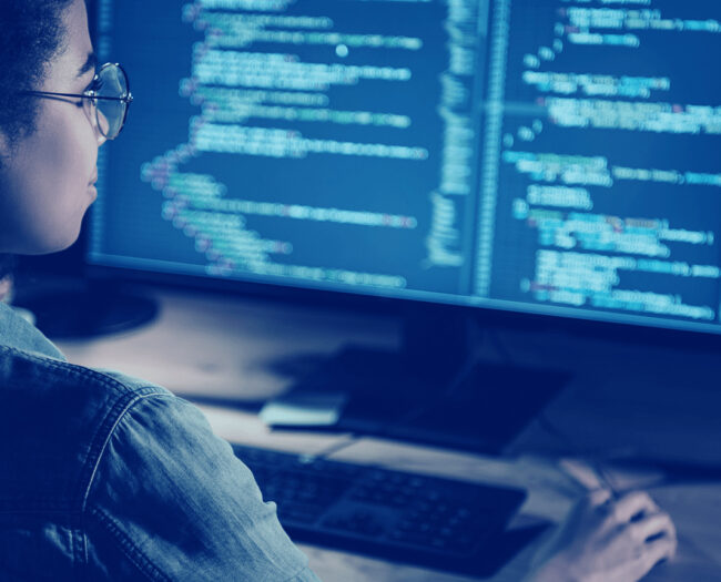 woman programming in front of a pc